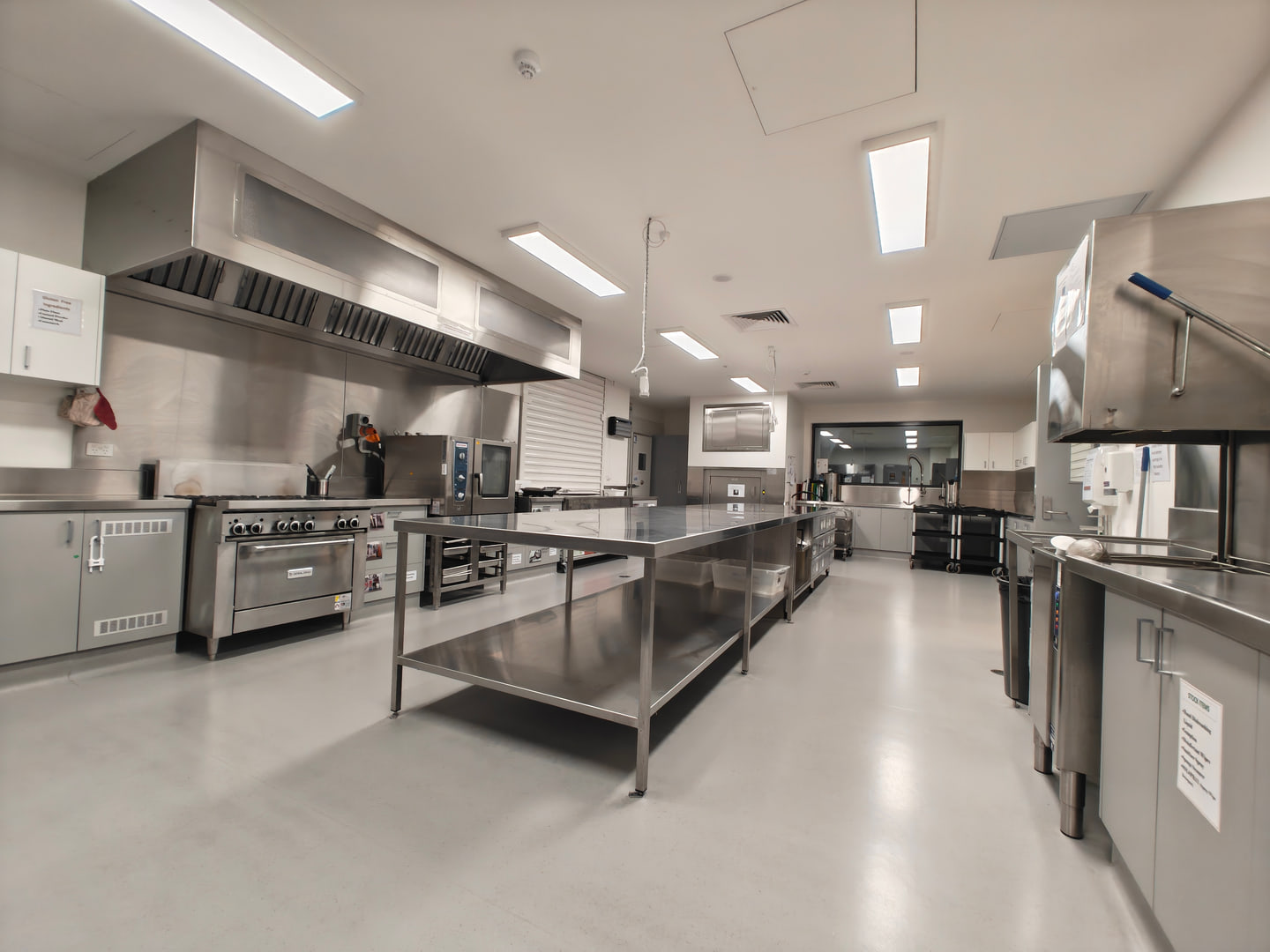 Clean stainless-steel commercial kitchen and preparation benches