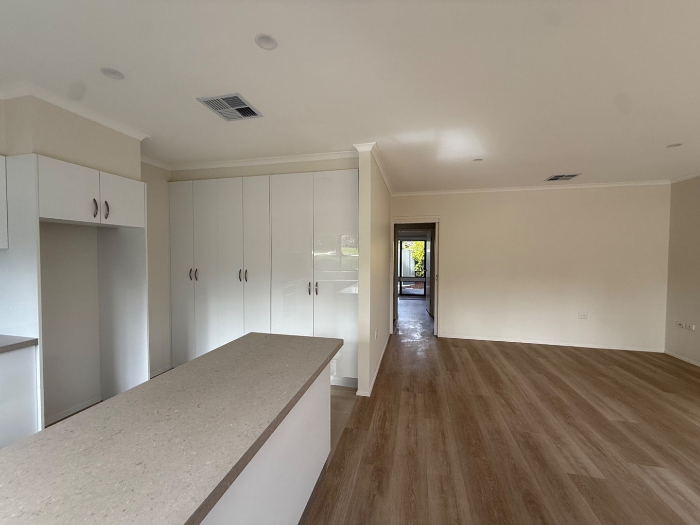 Wide view of a clean open-plan kitchen and living area
