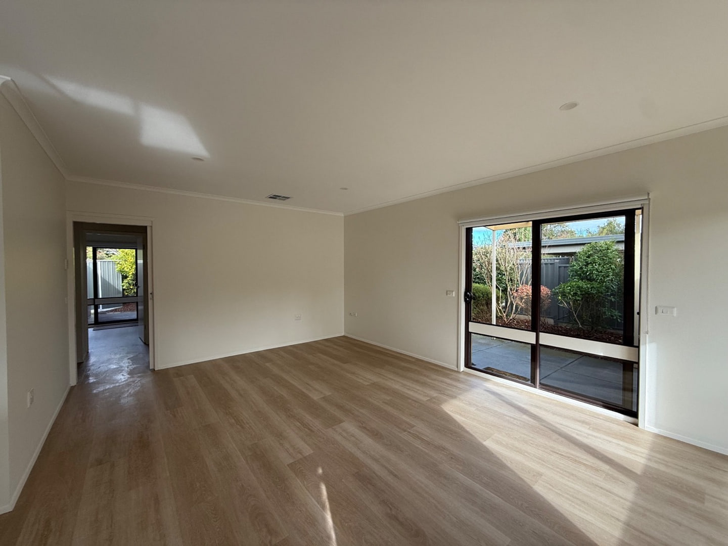 Clean open living area and hard floor prepared for handover